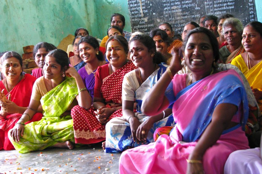 Group of women in India, sitting and smiling