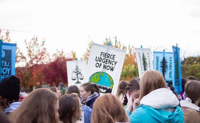 People holding up protest sign.